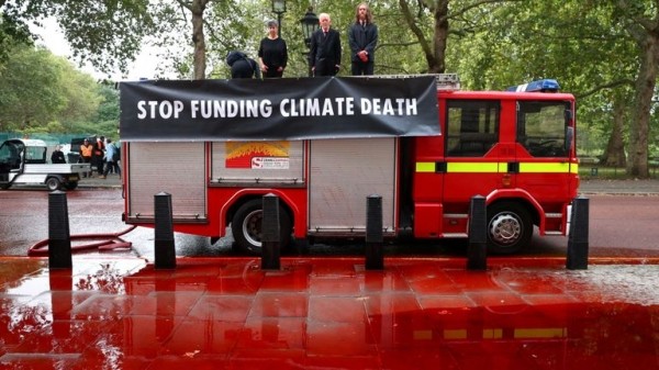 
                              Extinction Rebellion protesters use fire engine to spray Treasury with fake blood
                      