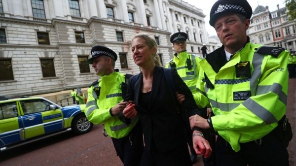 
                              Extinction Rebellion protesters use fire engine to spray Treasury with fake blood
                      